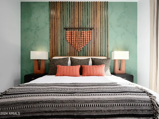 a bedroom with a large bed and a window