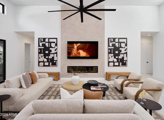 a living room with furniture a fireplace and a flat screen tv