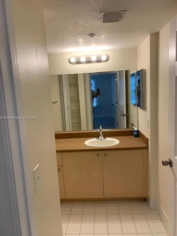 a view of a bathroom with a sink and mirror