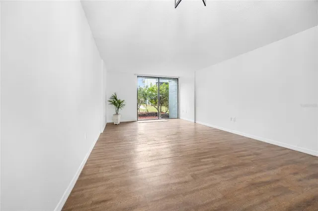 a view of an empty room and wooden floor