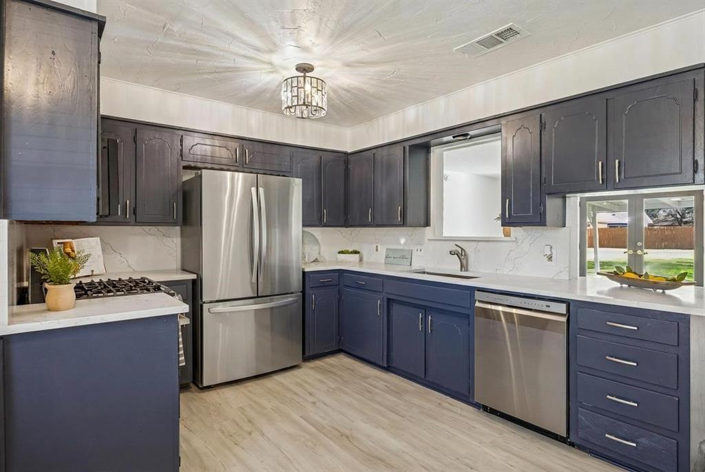 Brand new stainless appliances, a 5 burner gas cooktop and stunning quartz counters and backsplash, sink, faucet and garbage disposal.