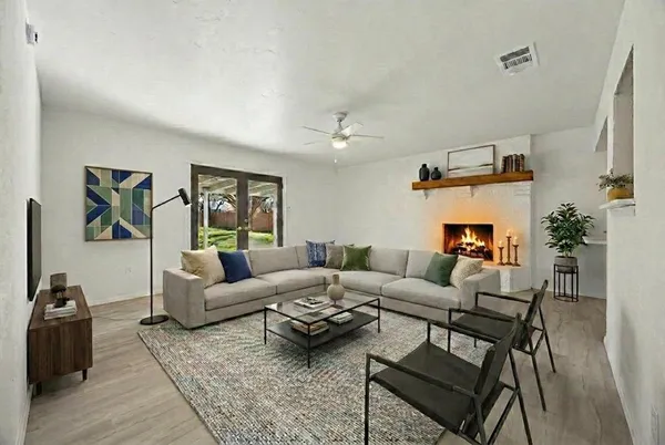a living room with furniture and wooden floor