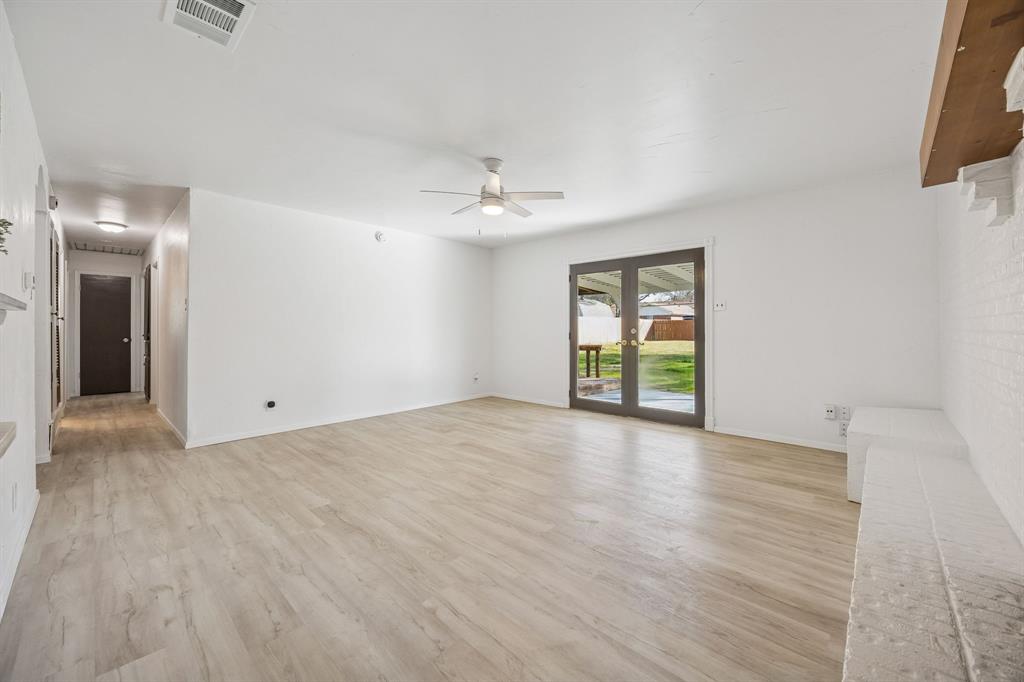312 East Hampton Road Crowley, TX 76036 - Photo 9 of 22 wooden floor in an empty room with a window