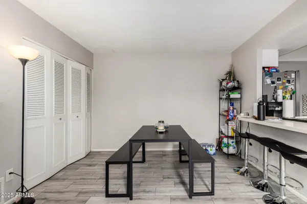 a view of a workspace with furniture and wooden floor