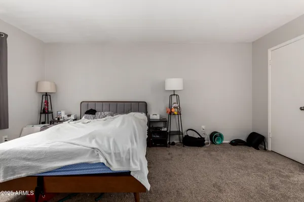 a bedroom with a bed and a table in it