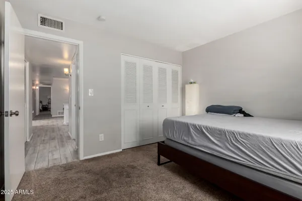 a bedroom with a bed and a mirror