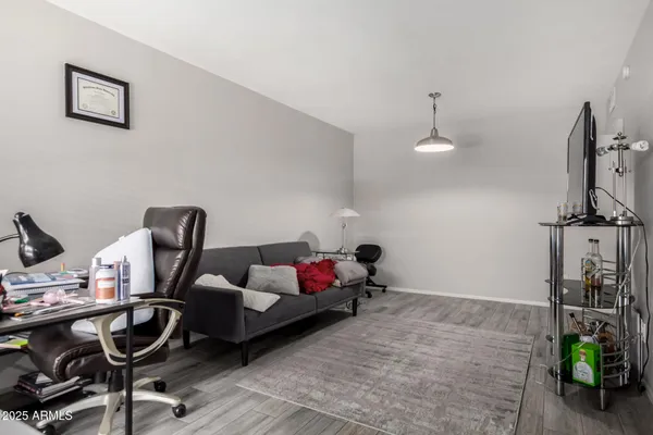 a bedroom with furniture and a wooden floor