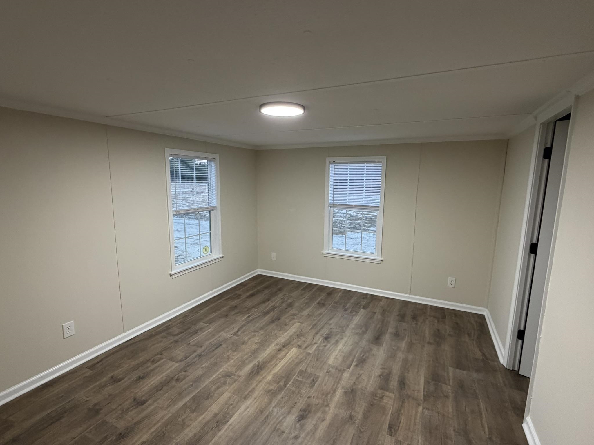 118 Nell Court Loris, SC 29569 - Photo 7 of 23 Unfurnished room featuring dark wood finished floors and baseboards
