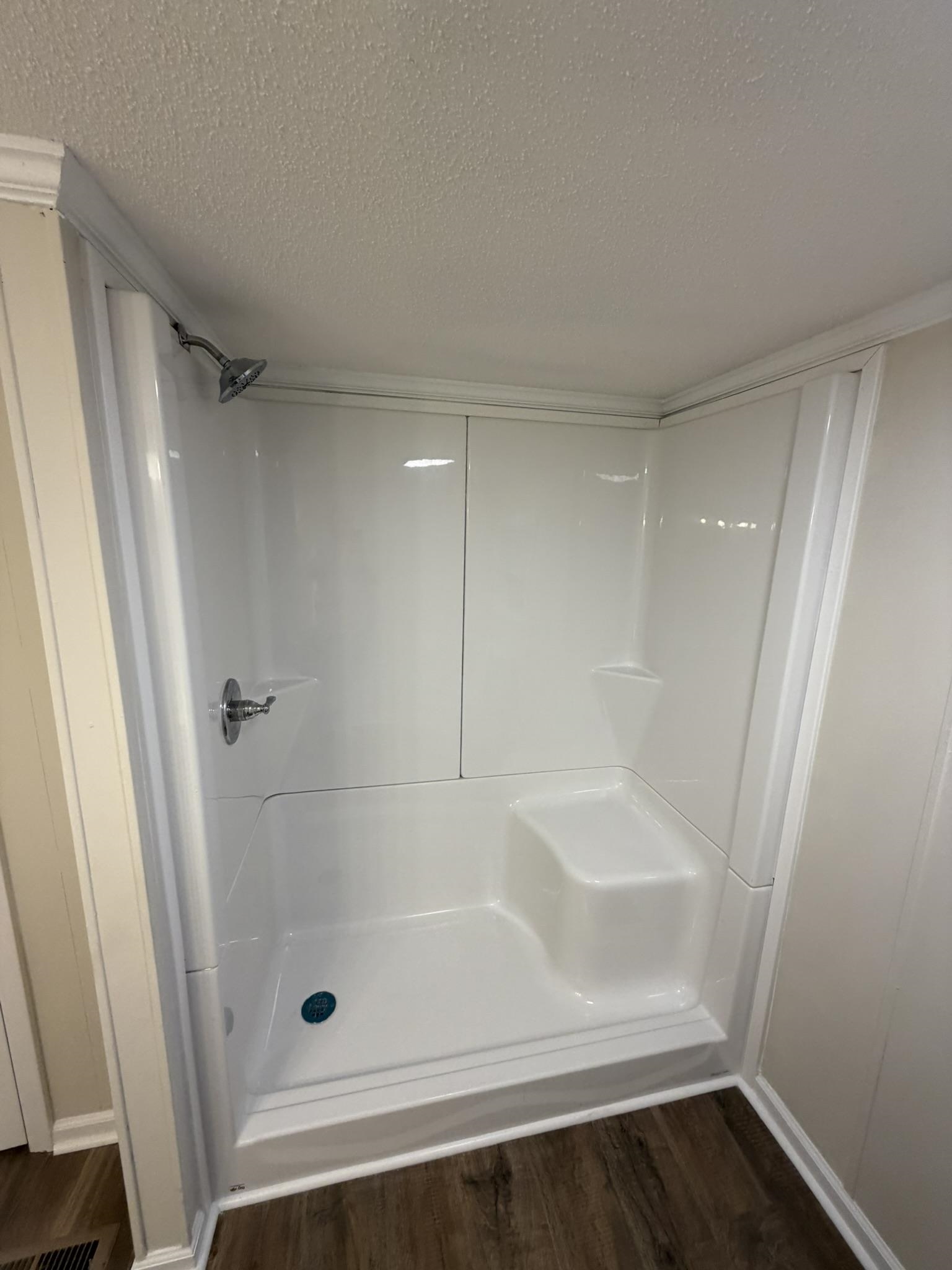 118 Nell Court Loris, SC 29569 - Photo 9 of 23 Full bathroom with a shower stall, a textured ceiling, and dark wood-type flooring
