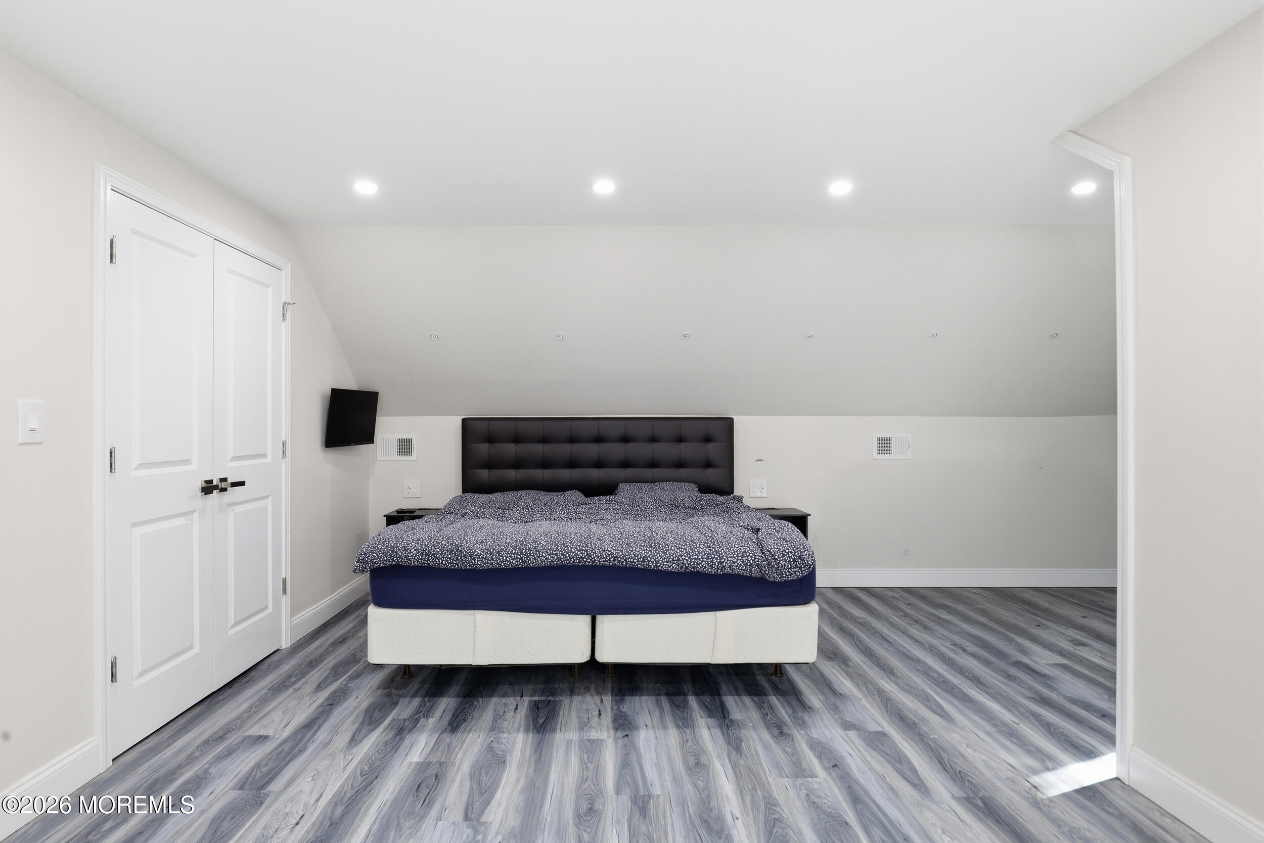 492 Cobain Road Jackson, NJ 08527 - Photo 32 of 47 a spacious bedroom with a bed and wooden floor