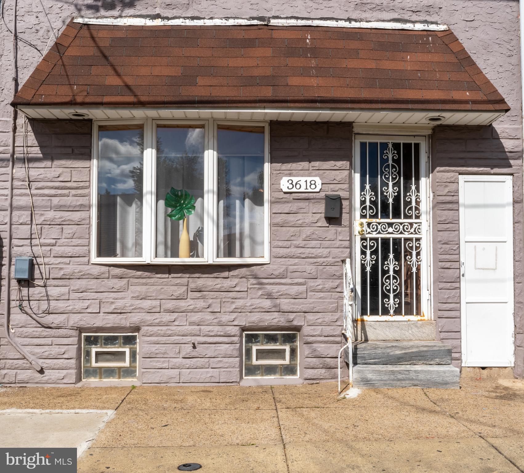 3618 Emerald Street Philadelphia, PA 19134 - Photo 1 of 34 a front view of a house with glass windows