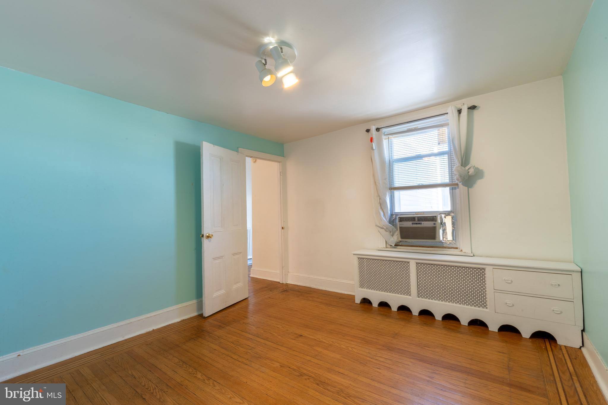 3618 Emerald Street Philadelphia, PA 19134 - Photo 12 of 34 an empty room with wooden floor and windows