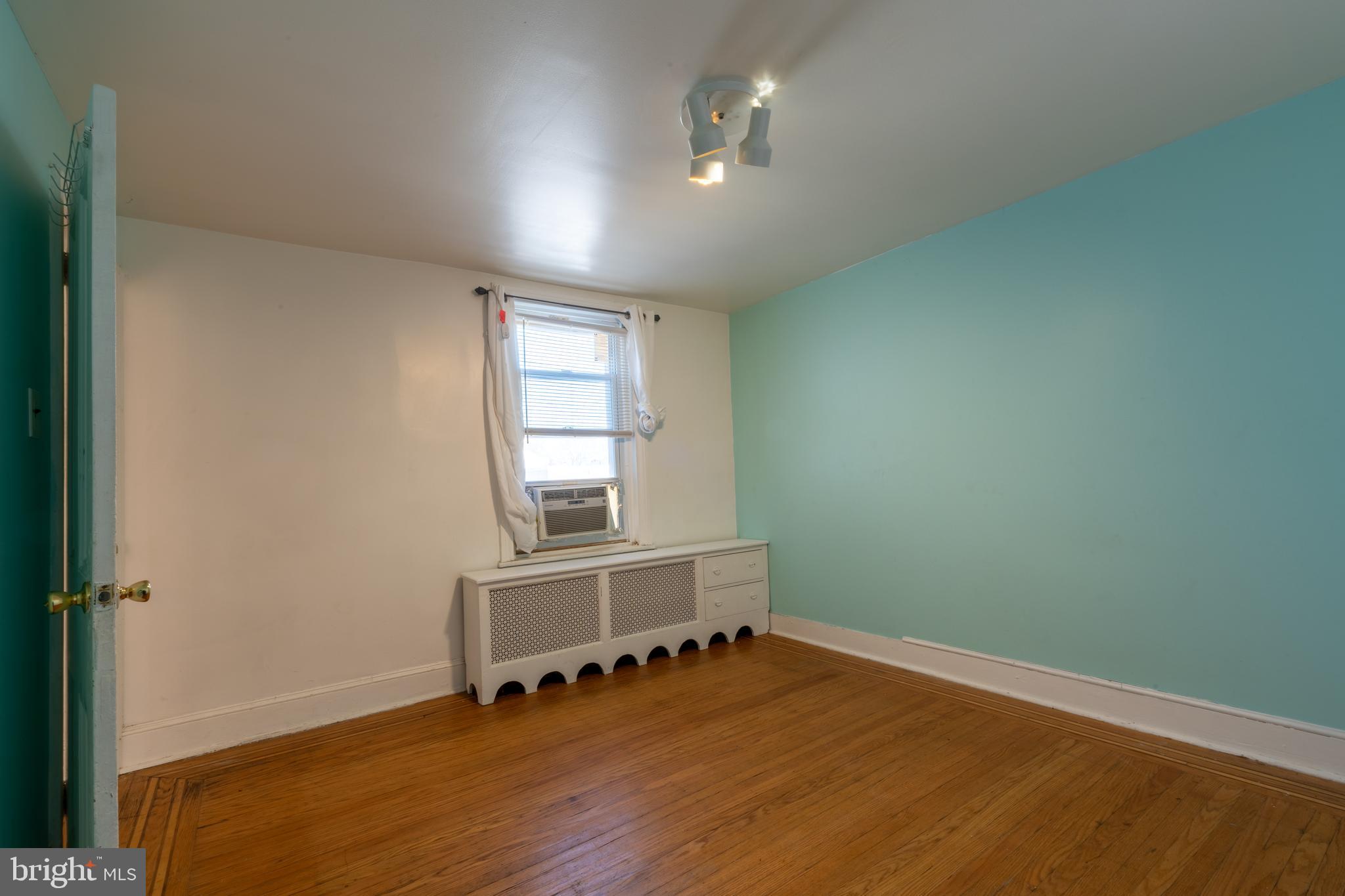 3618 Emerald Street Philadelphia, PA 19134 - Photo 13 of 34 an empty room with wooden floor and windows