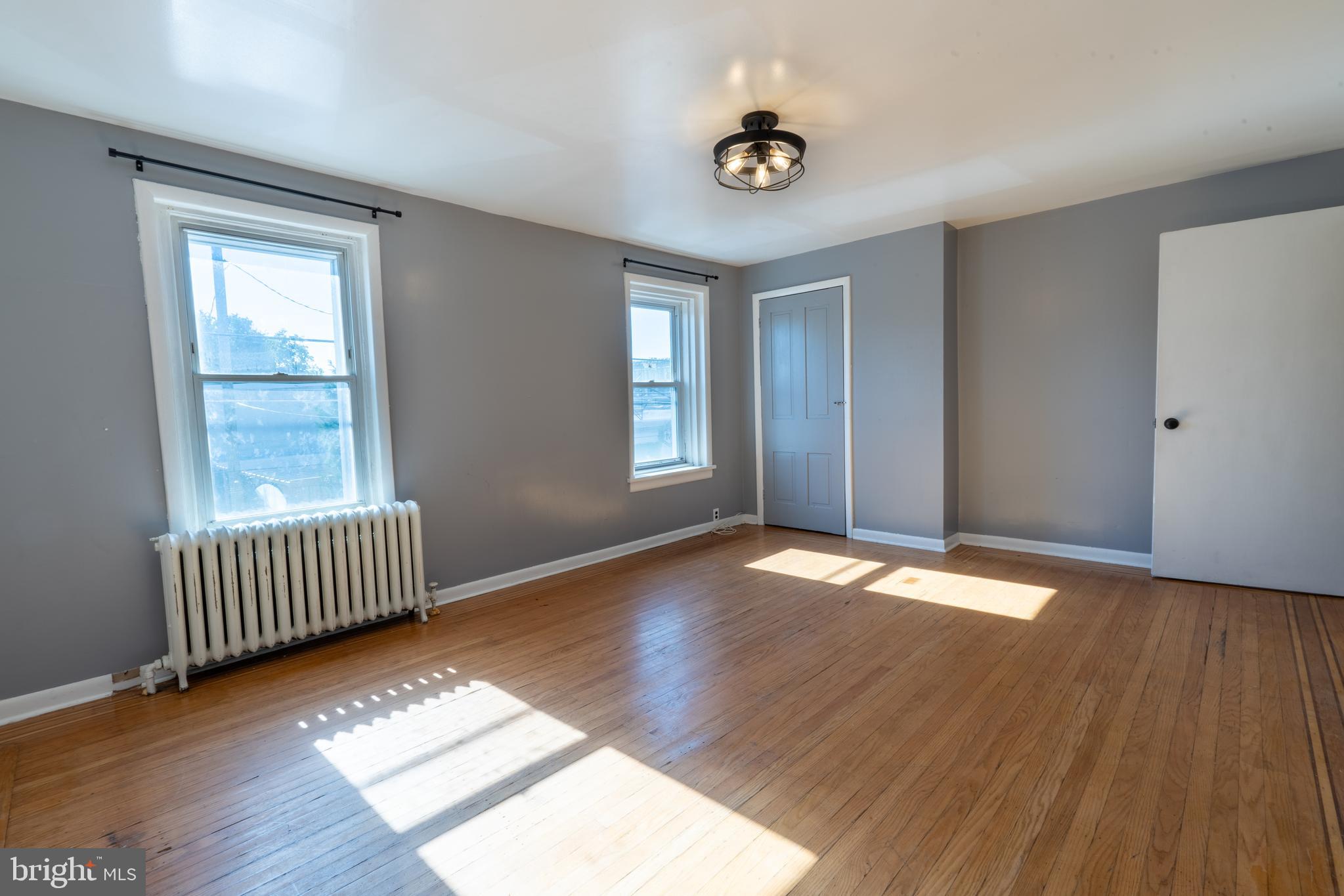 3618 Emerald Street Philadelphia, PA 19134 - Photo 16 of 34 a view of an empty room with window and wooden floor