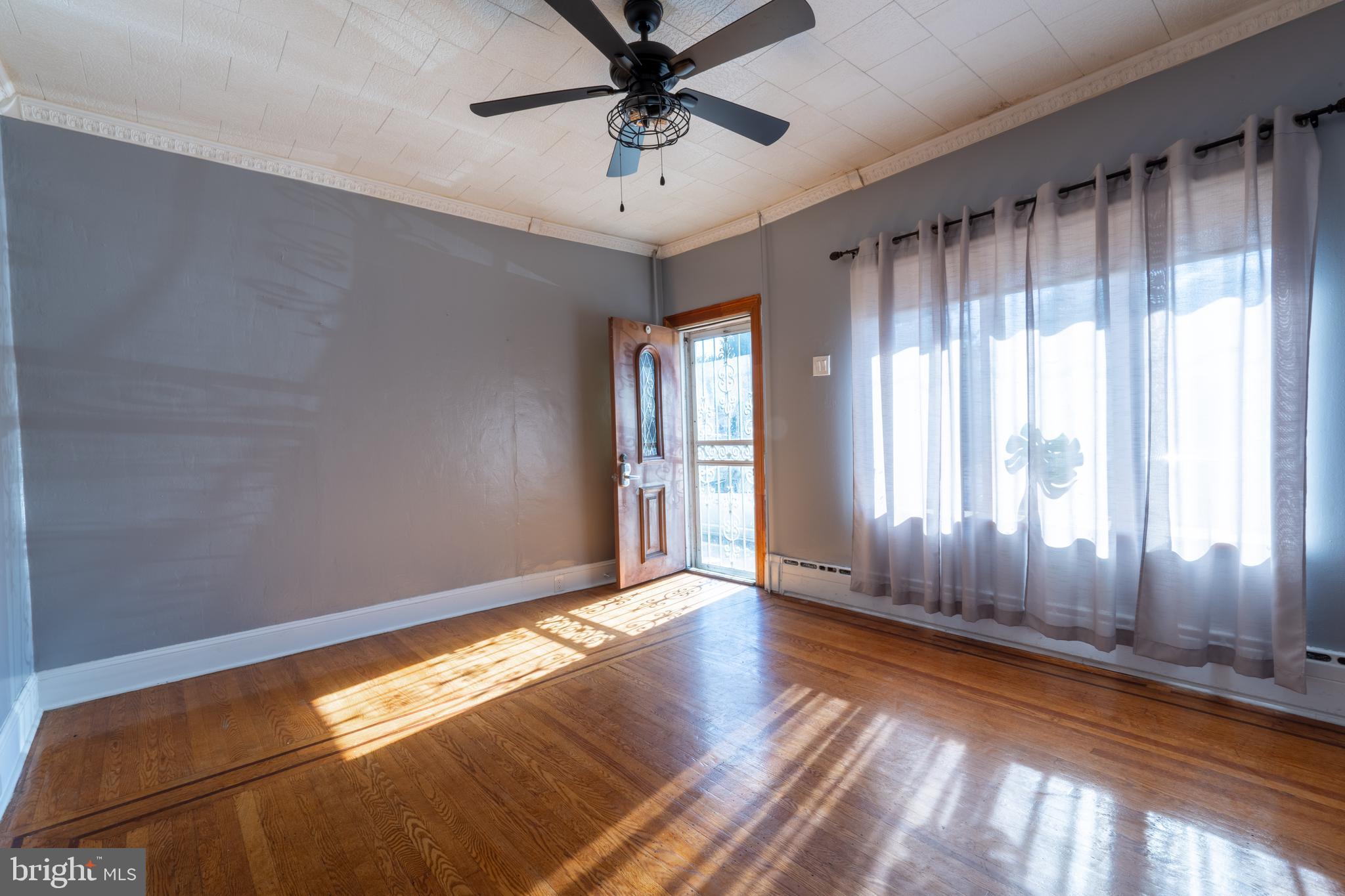 3618 Emerald Street Philadelphia, PA 19134 - Photo 2 of 34 a view of a livingroom with a ceiling fan and window
