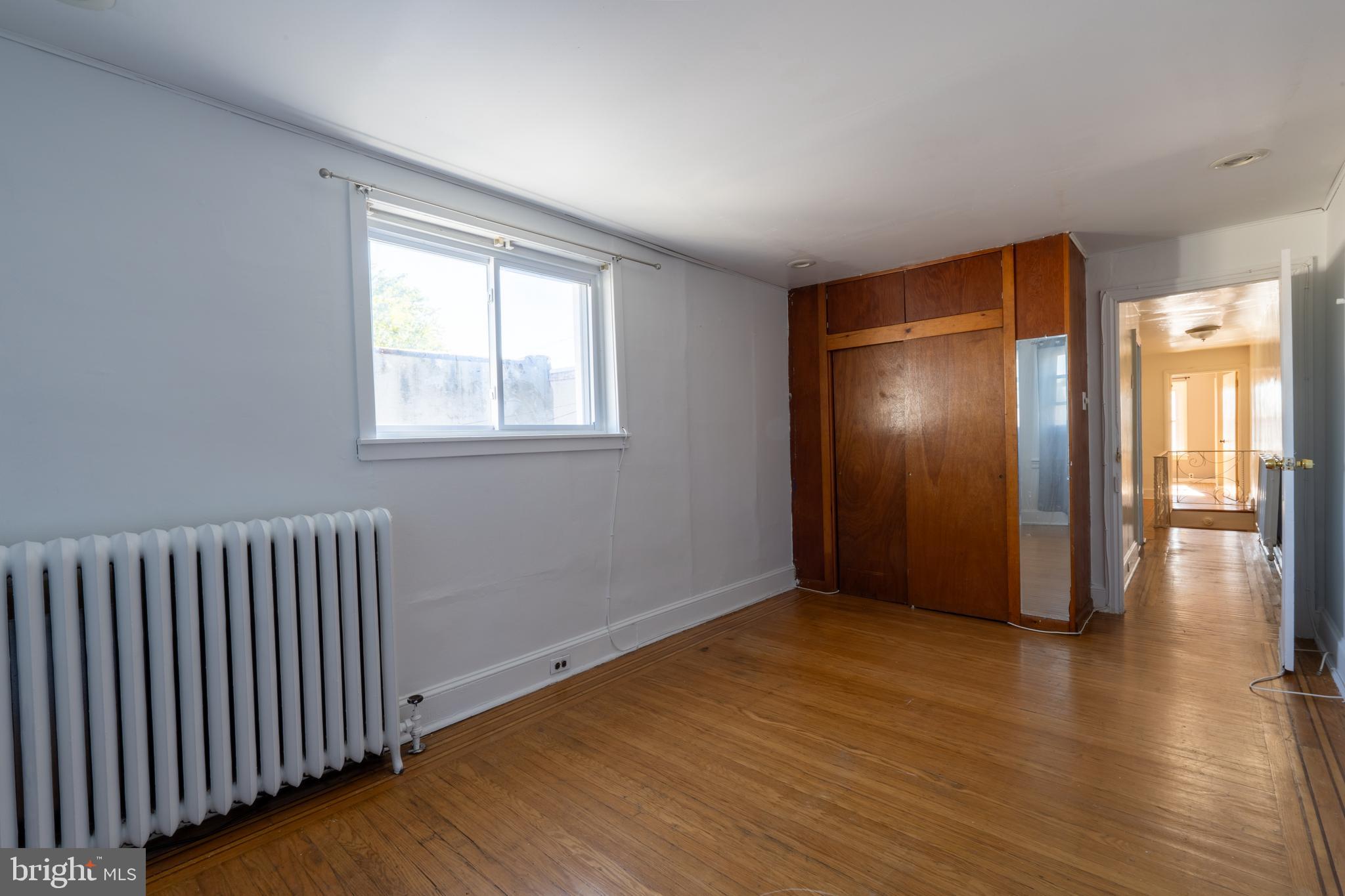 3618 Emerald Street Philadelphia, PA 19134 - Photo 7 of 34 an empty room with wooden floor and windows