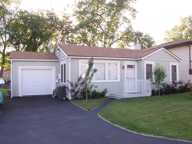 130 Bay Road Fox Lake, IL 60020 - Photo 1 of 21 a view of a house with a yard and a garden