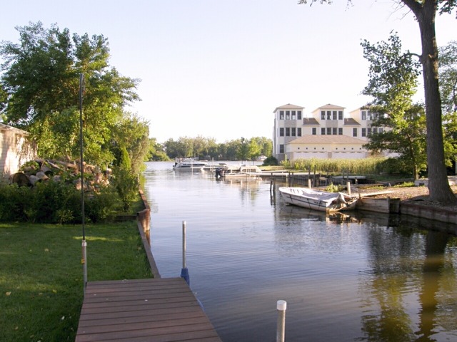 130 Bay Road Fox Lake, IL 60020 - Photo 2 of 21 a view of a lake with a yard and large trees