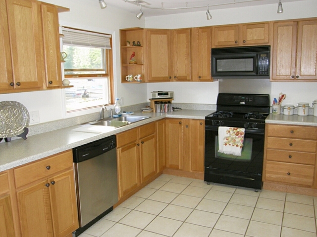 130 Bay Road Fox Lake, IL 60020 - Photo 11 of 21 a kitchen with a sink stove and microwave