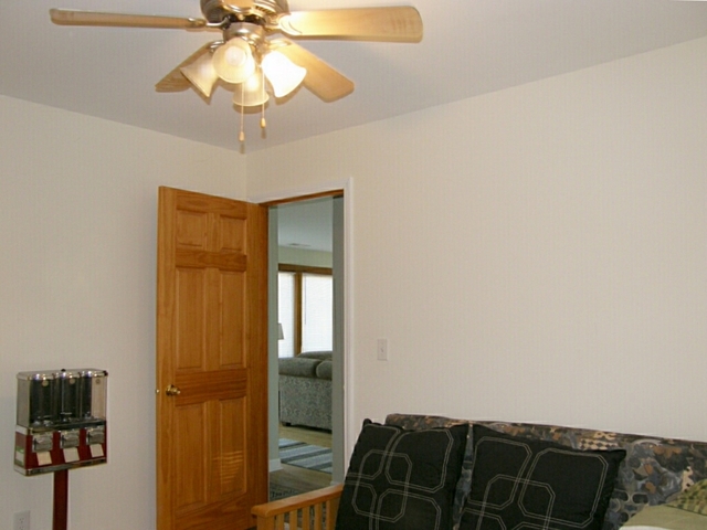 130 Bay Road Fox Lake, IL 60020 - Photo 19 of 21 a bedroom with a bed and a chandelier