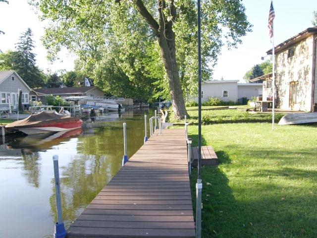 130 Bay Road Fox Lake, IL 60020 - Photo 4 of 21 a lake view with a sitting space and large trees