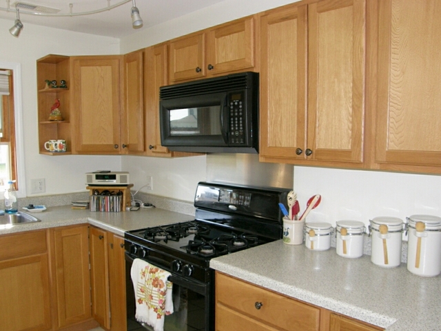 130 Bay Road Fox Lake, IL 60020 - Photo 10 of 21 a kitchen with granite countertop wood cabinets and a stove top oven