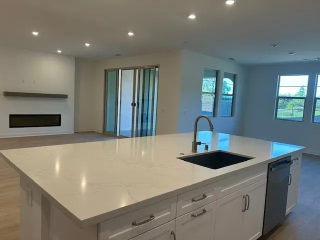 a large kitchen with stainless steel appliances a refrigerator and a stove top oven