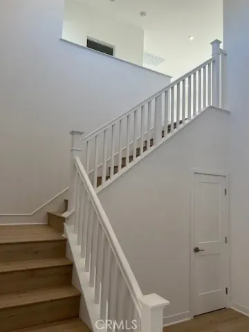 a kitchen with white cabinets and sink