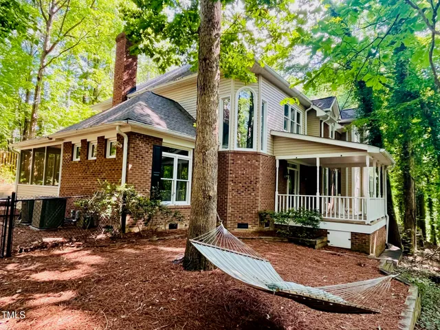 a front view of a house with yard and green space