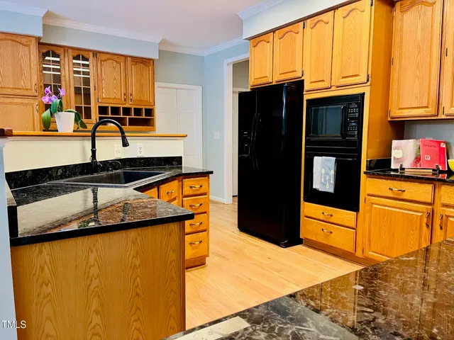 a kitchen with stainless steel appliances granite countertop cabinets and a stove top oven