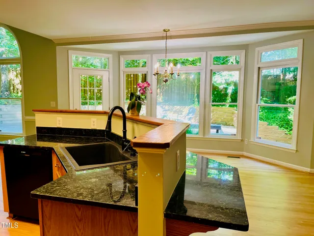 a kitchen with stainless steel appliances a stove sink and cabinets