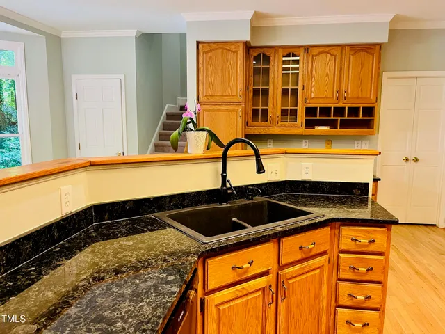 a kitchen with stainless steel appliances granite countertop a stove and a refrigerator
