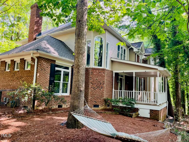 a view of house with a yard