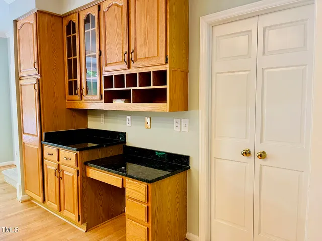 a kitchen with stainless steel appliances granite countertop a refrigerator a sink and a stove