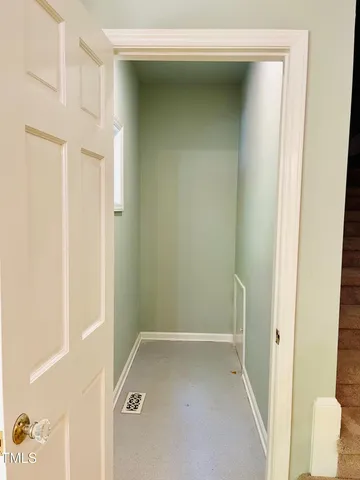 a view of a room with wooden floor and floor to ceiling windows