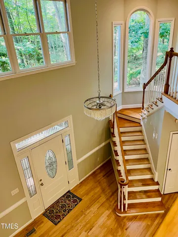 a view of a room with wooden floor and stairs