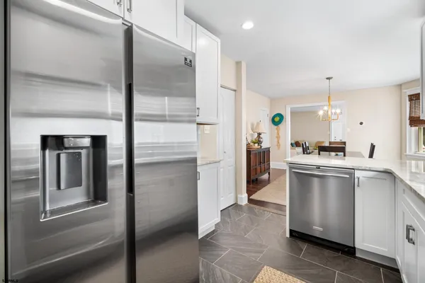 a kitchen with a refrigerator and a sink