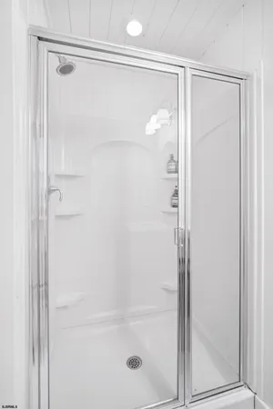 a bathroom with a glass shower door