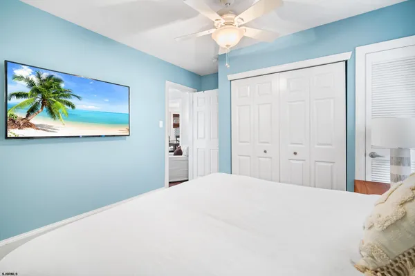 a bedroom with a bed and a painting on the wall