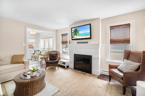 a living room with furniture a fireplace and a flat screen tv