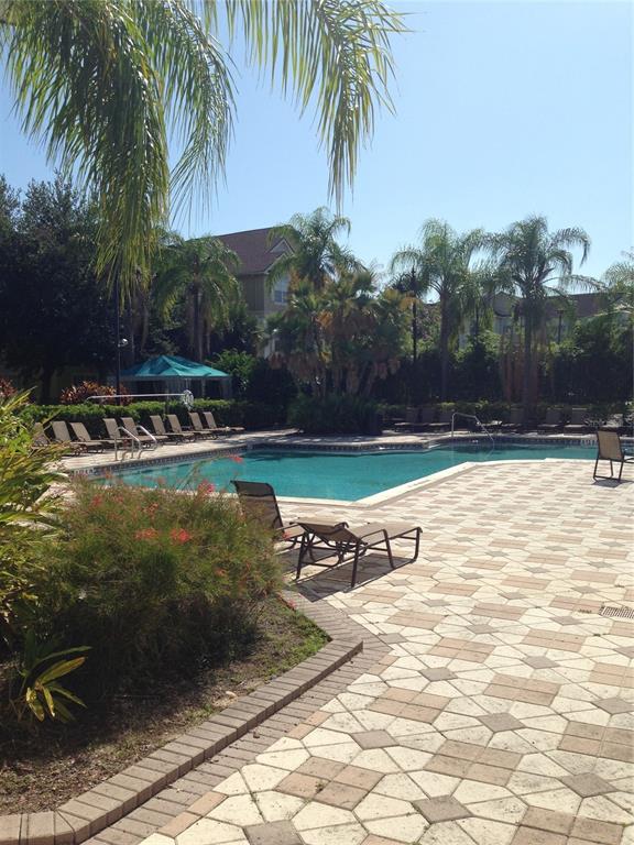 3355 South Kirkman Road, Unit 1324 Orlando, FL 32811 - Photo 16 of 19 a view of a backyard with a table and chairs
