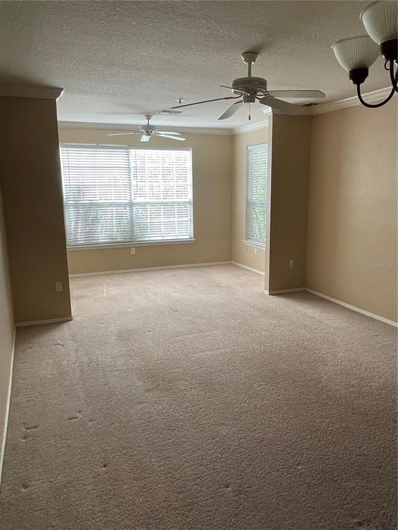 3355 South Kirkman Road, Unit 1324 Orlando, FL 32811 - Photo 5 of 19 an empty room with windows and ceiling fan