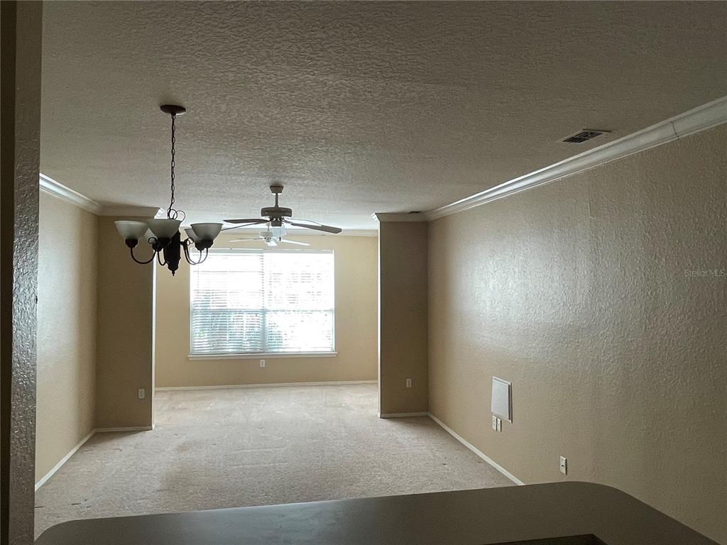 3355 South Kirkman Road, Unit 1324 Orlando, FL 32811 - Photo 7 of 19 a view of a room with windows and ceiling fan