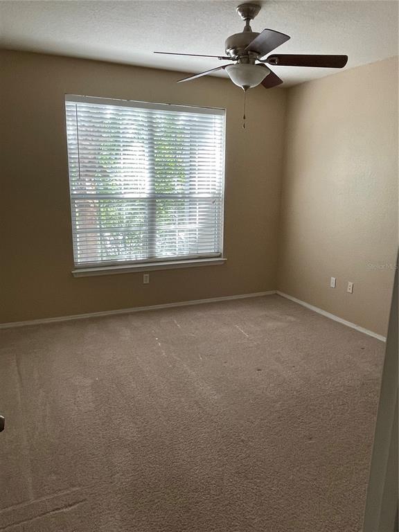 3355 South Kirkman Road, Unit 1324 Orlando, FL 32811 - Photo 10 of 19 a view of a livingroom with a ceiling fan and window