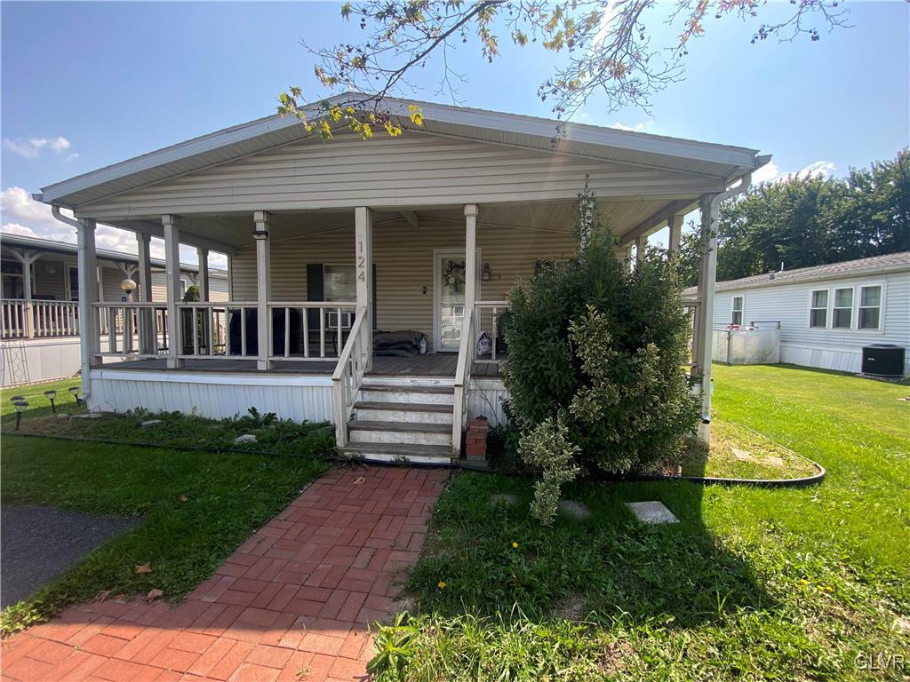a view of a house with backyard and porch