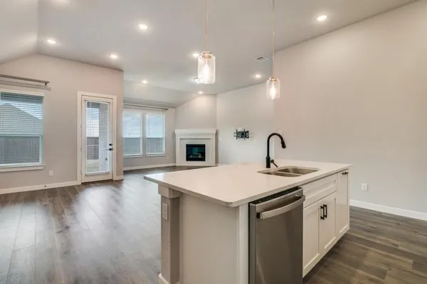 a large kitchen with stainless steel appliances kitchen island a large counter top and a stove top oven
