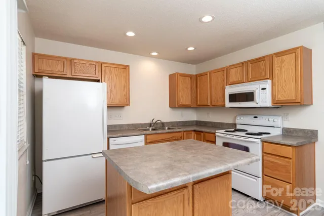 a kitchen with a refrigerator sink and microwave