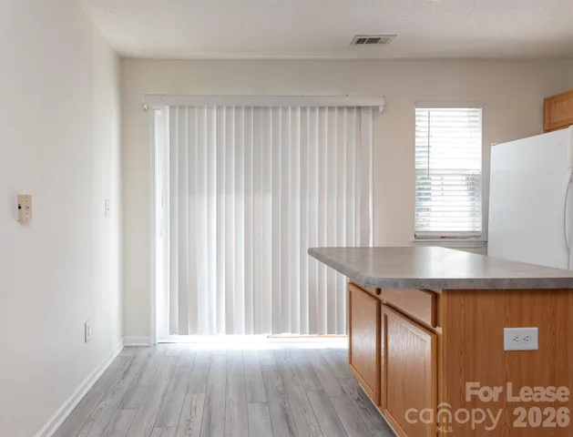 a kitchen with kitchen island wooden floor and window
