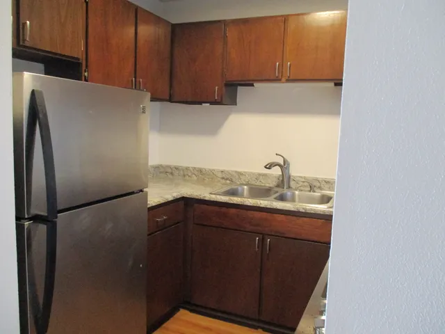 a kitchen with a refrigerator and cabinets