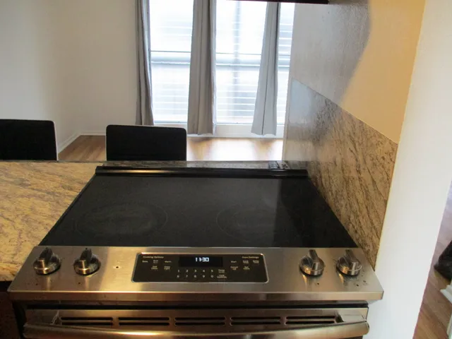a stove top oven sitting on top of a granite counter